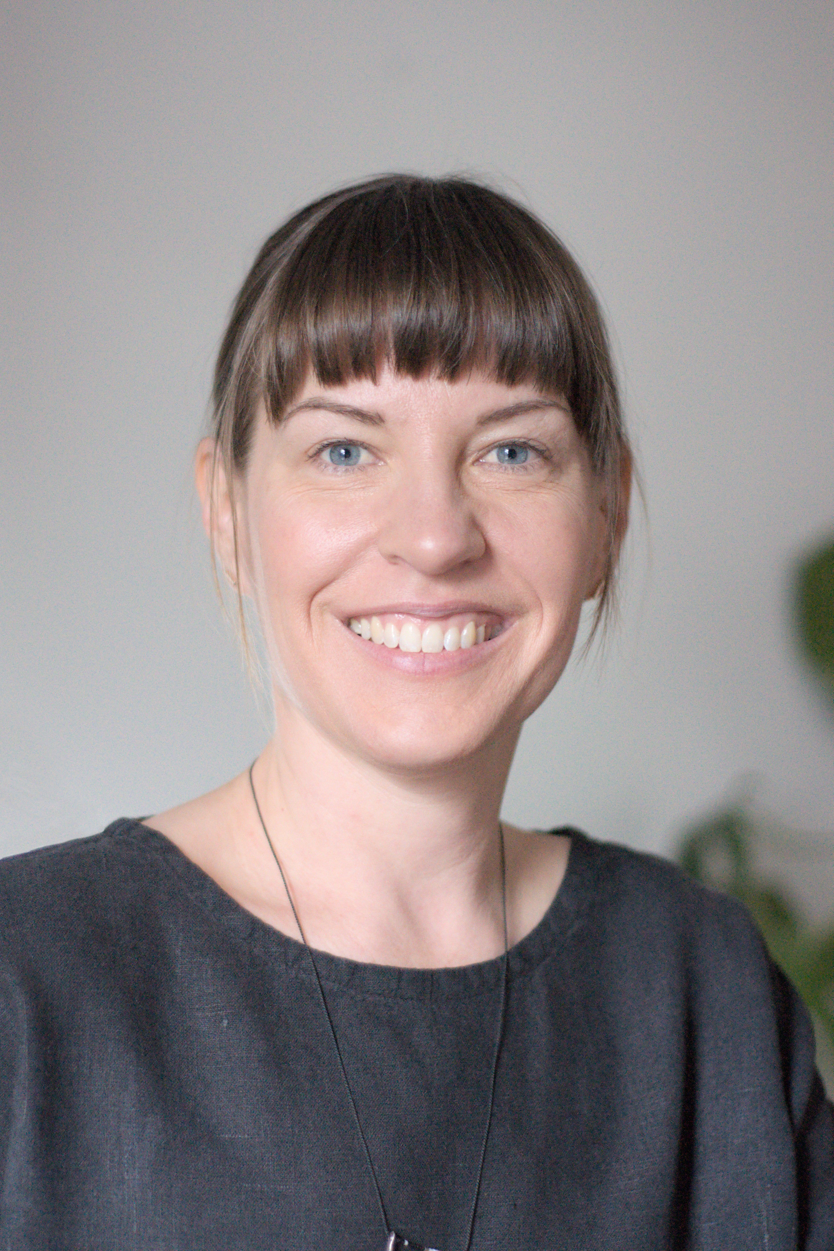 Lauren Champs sitting at her desk and smiling at the camera